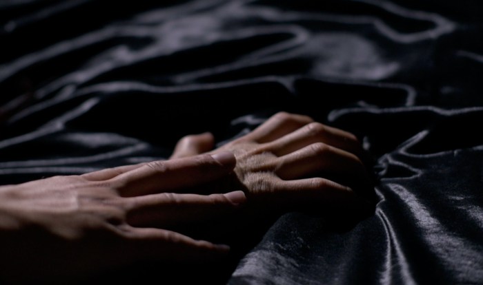The interweaving of male hands