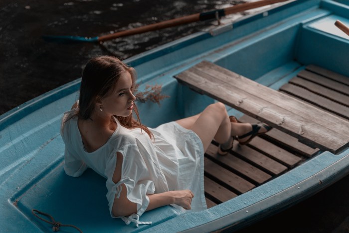 Photoshoot in a boat girl in a dress