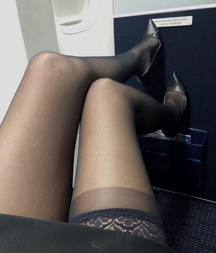 Legs in pantyhose under the table