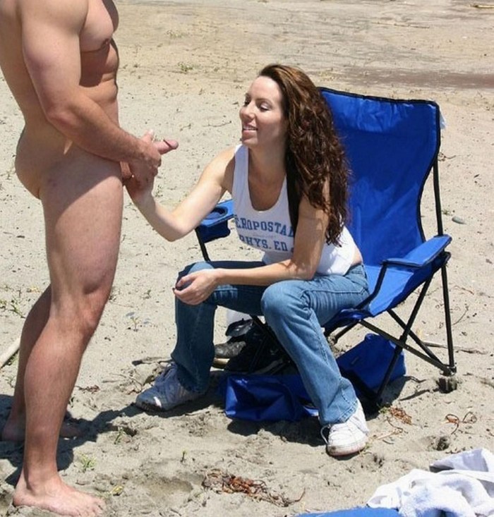 Wife with a black man on the beach on vacation