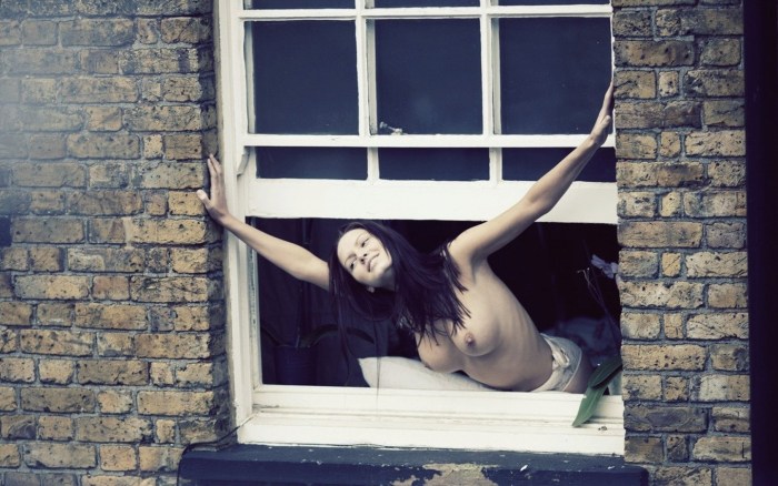 Naked women in the windows of houses