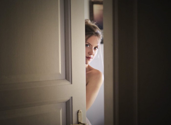 The woman opens the door