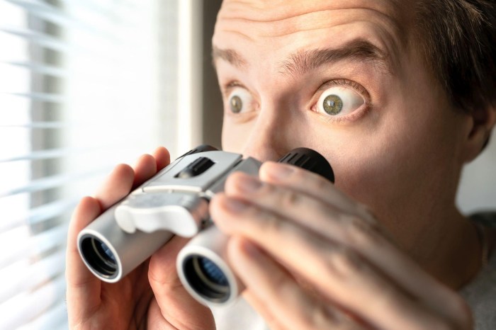 Surprised man with binoculars