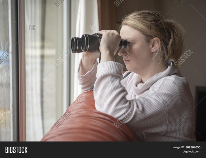 A woman with agrophobia is watching neighbors