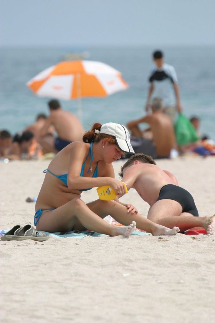 Women sunbathe topless