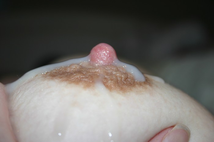 Cums on tits close -up