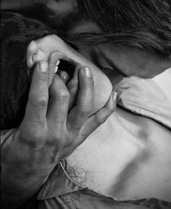 Men's hands in a woman's mouth