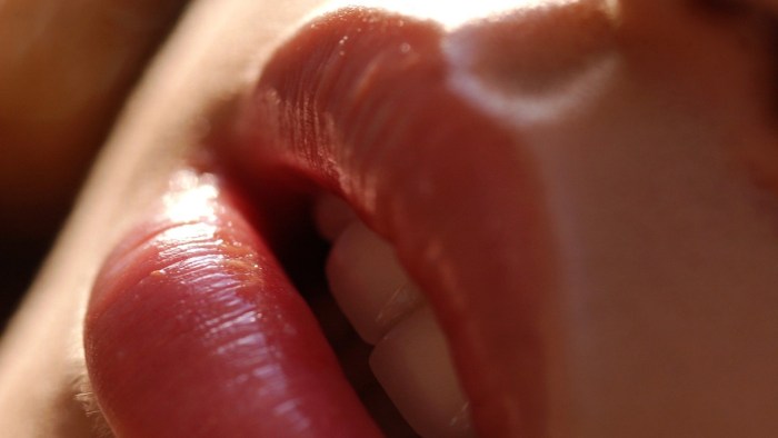 Licks lips from pleasure
