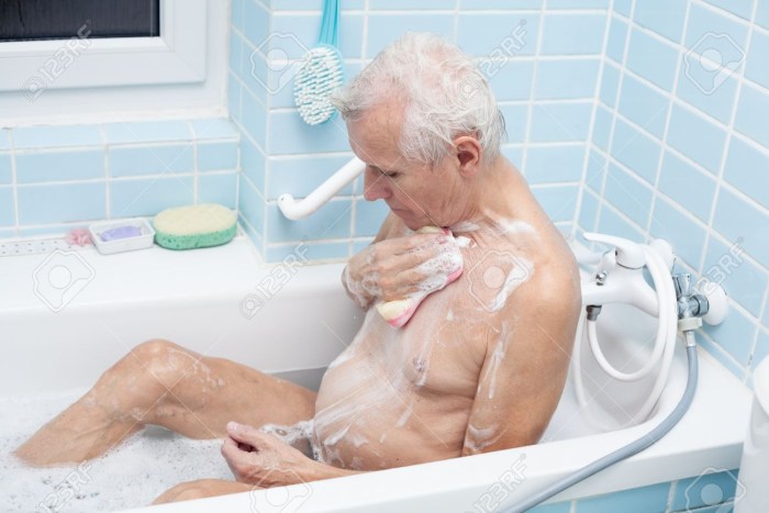 An elderly man washes