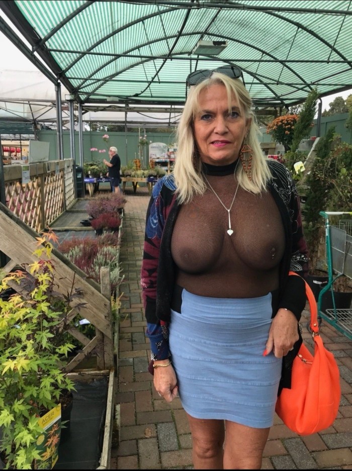 Naked lady in 50 years in a transparent dress