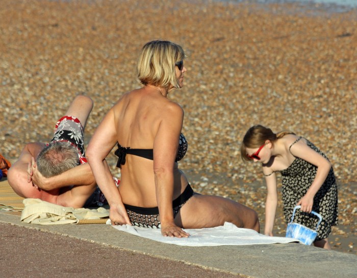 Older women sunbathe on the beach