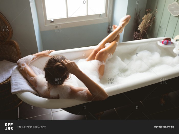 Bath with foam girl in jacuzzi