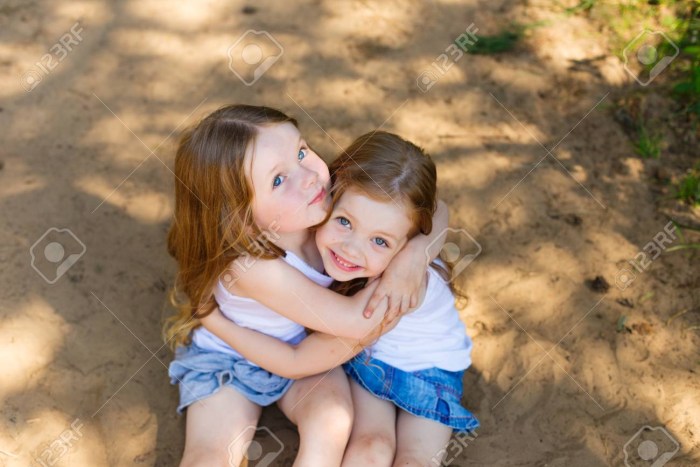 Two little girlfriends hug