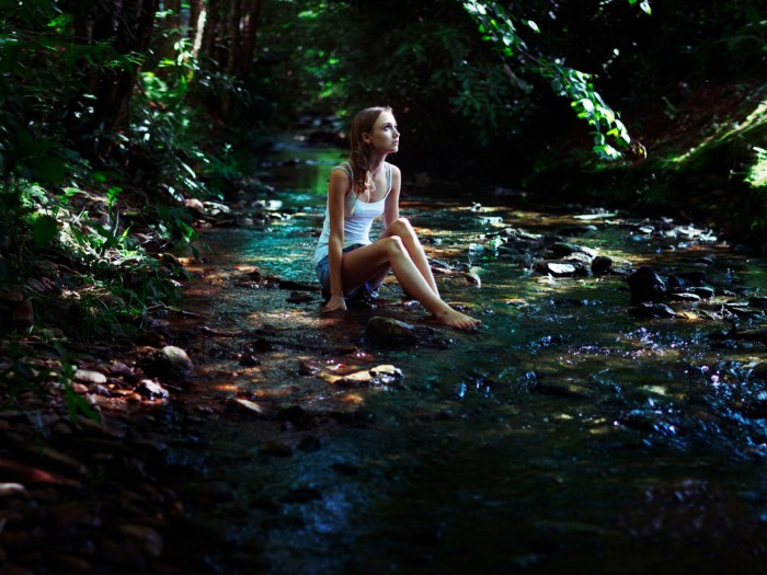 Girl swimming in a forest lake