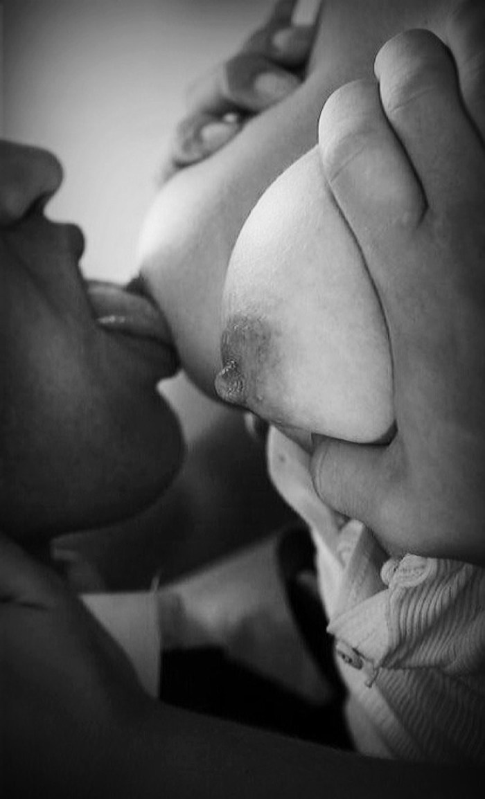 Man caresses female breasts