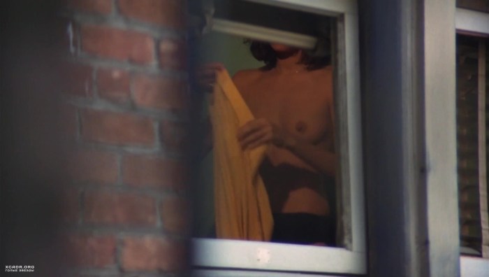 Peeping out the window behind the neighbor
