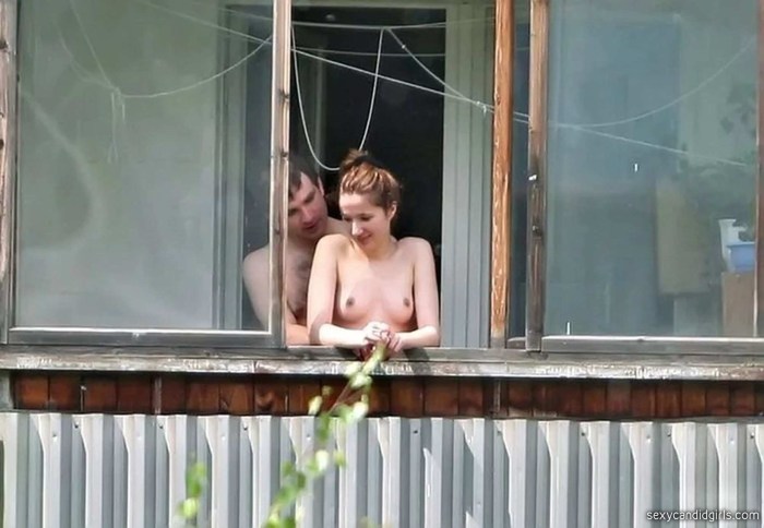 Naked women in the windows of houses
