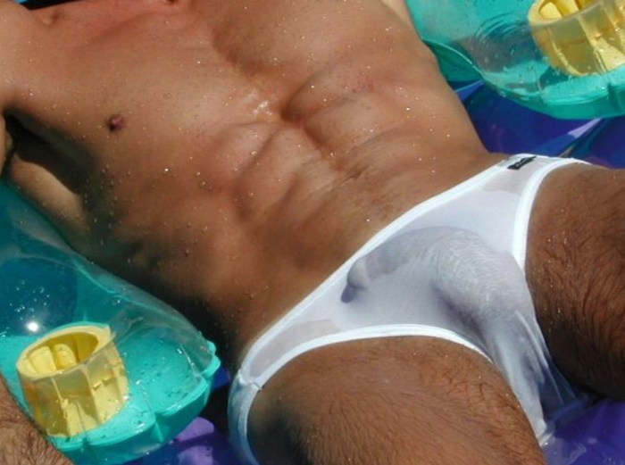 A guy in wet underpants on the beach