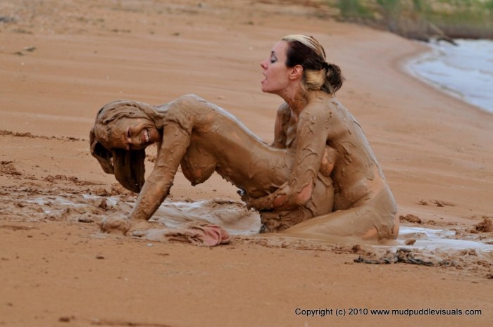 Naked girls bathed in mud