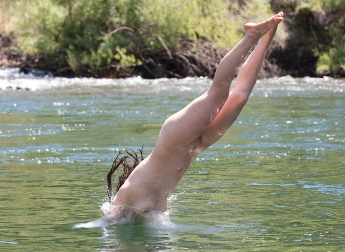 Naked women jump into the water