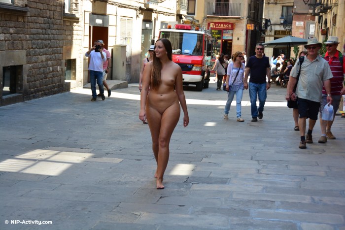 A naked woman walks around the city